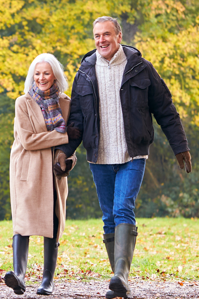 Image of middle age couple walking in park.